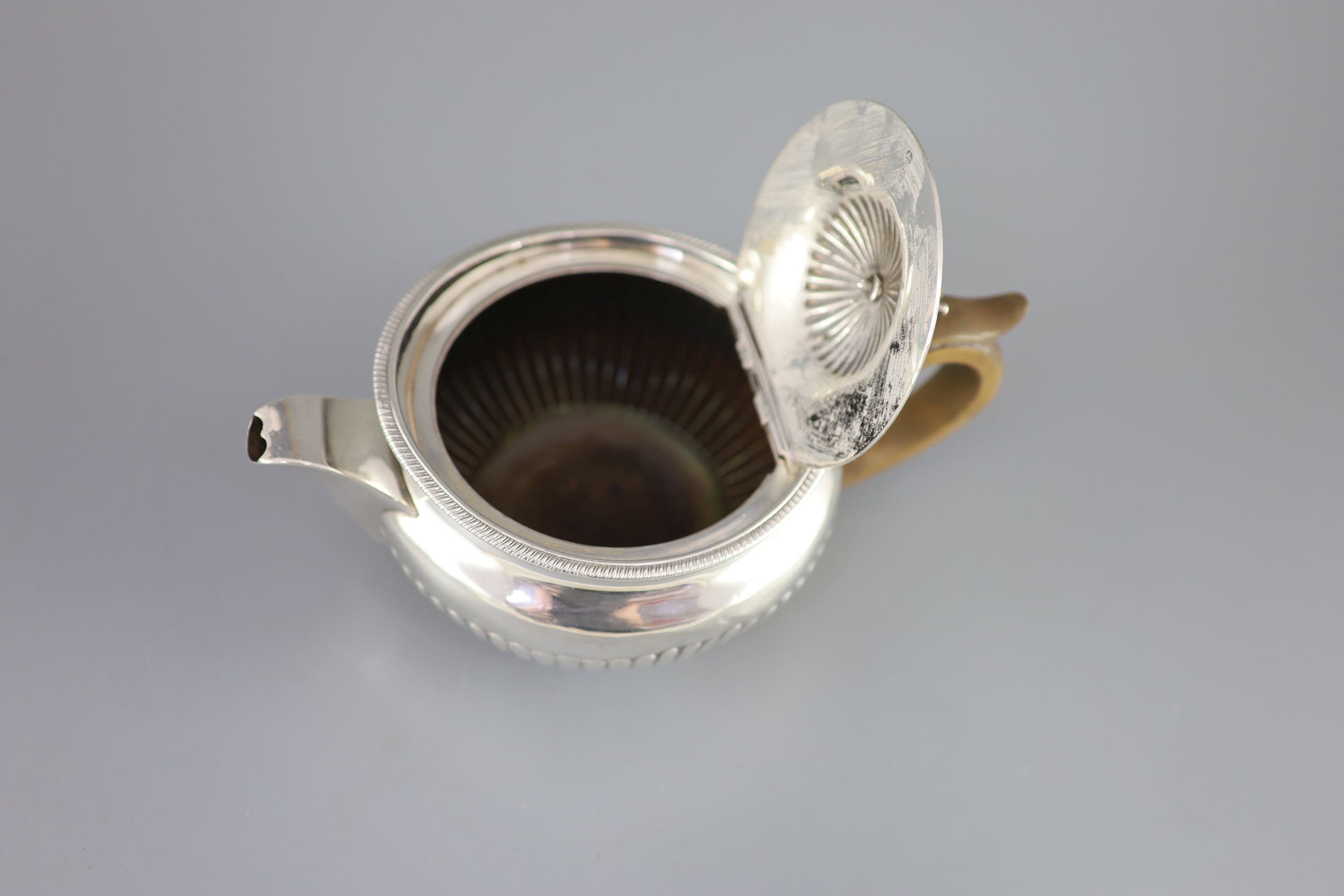 A George III demi-fluted silver squat circular teapot, by Robert & Samuel Hennell